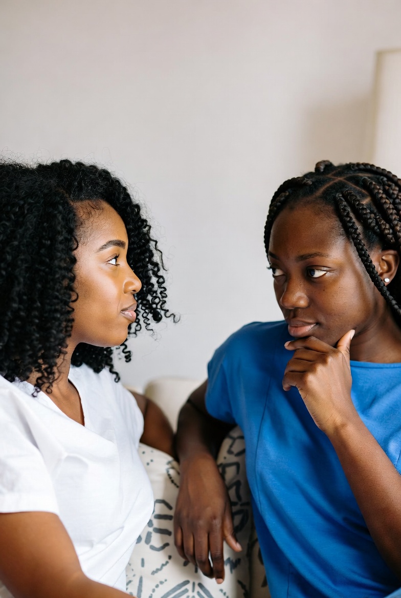 Black African adults coding together with laptops